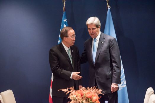 FRANCE, Paris: US Secretary of State John Kerry shakes hands with UN Secretary General Ban Ki-moon during the United Nations Climate Change Conference in Paris, France on December 11, 2015.