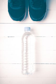 running shoes and drinking water on white table vintage style