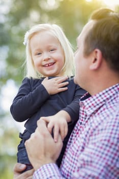 Adorable Little Baby Girl Having Fun With Daddy Outdoors.