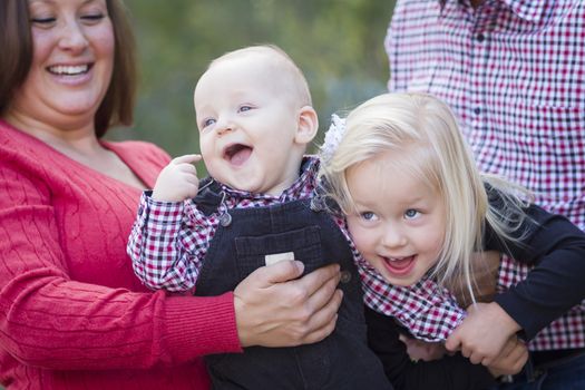 Mommy and Daddy Having Fun with Cute Baby Brother And Sister.