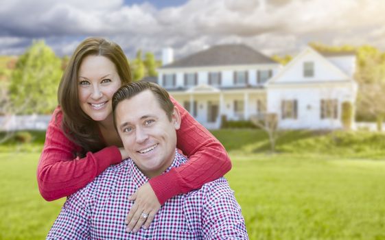 Happy Affectionate Couple Outdoors In Front of Beautiful House.