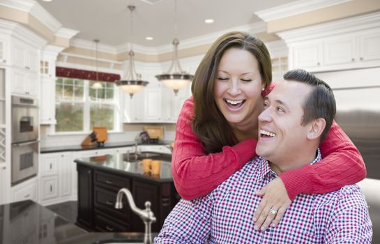 Happy Laughing Affectionate Couple In Beautiful New Kitchen.