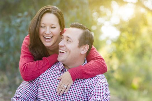 Attractive Happy Caucasian Couple Laughing Outdoors.