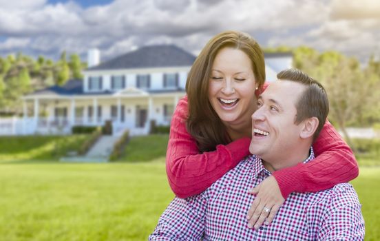 Happy Affectionate Laughing Couple Outdoors In Front of Beautiful House.