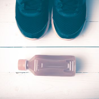running shoes and orange juice on white wood table vintage style