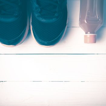 running shoes and orange juice on white wood table vintage style