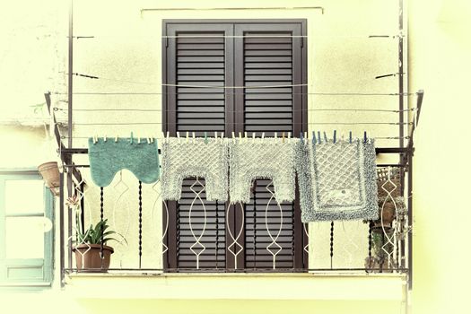 Italian Balcony in Palermo with Closed Wooden Shutters, Decorated with Mats, Retro Image Filtered Style