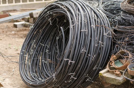 pile of old electrical high-voltage wires lying on the ground