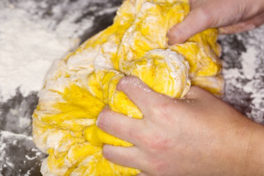 Hands in Saffron Bun Dough close up image.