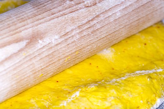 Saffron Bun Dough with Roller close up macro image.