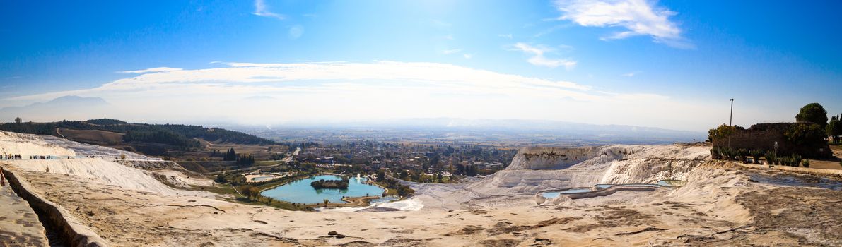 Panoramic view of white hill in Pamukkale and pools on clear sky background, Denizli, Turkey.