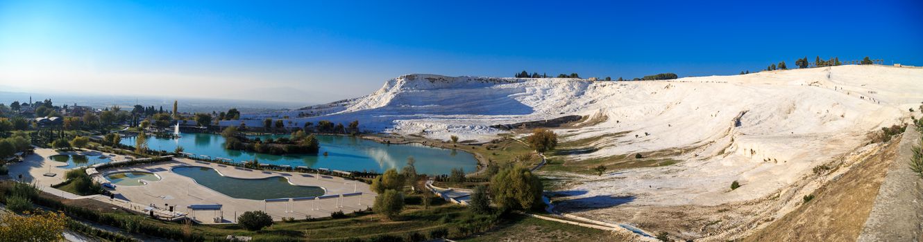 PAMUKKALE, TURKEY - NOVEMBER 16, 2015: Panoramic view of white hills in Pamukkale. Pamukkale is a famous historical place with travertine pools and  terraces in Denizli.