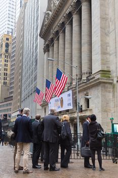 New York City, United States of America - March 26: Businessmen on Wall street in front of New York Stock Exchange on March 26, 2015.