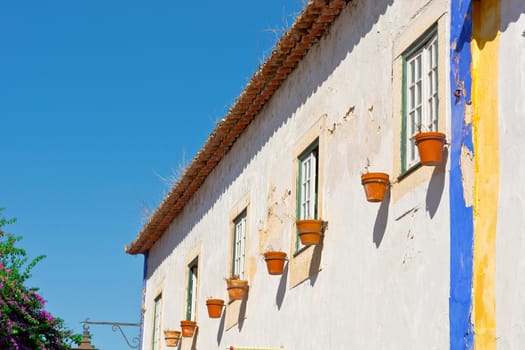 Shabby Facade of Portuguese  House Decorated with Flower Pots