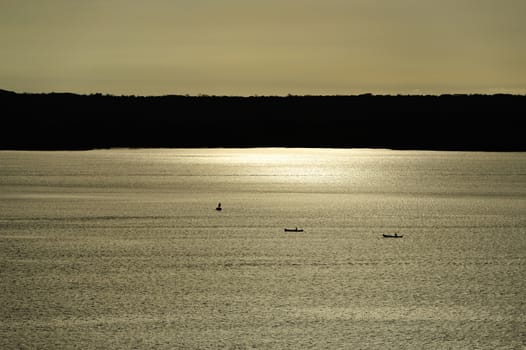 Fish boats in sunset light