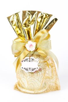 golden gift sack of tea cup on white background
