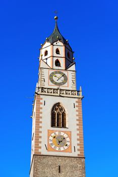 Detail of the bell tower of the Cathedral of St. Nicholas (1302-1465) in Merano, Bolzano, Trentino Alto Adige, Italy