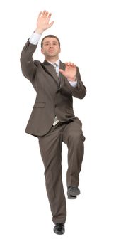 Businessman climbing empty space on isolated white background, front view