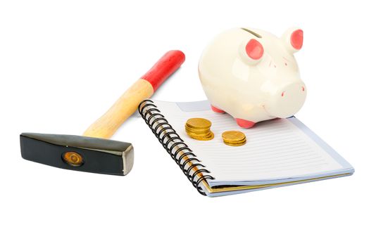 Piggy bank with hammer and coins on isolated white background