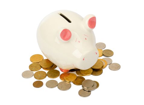 Piggy bank with coins on isolated white background