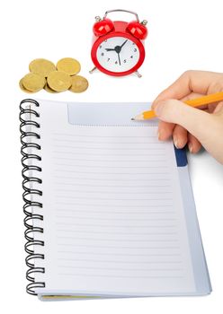 Hand writing in notebook with alarm clock on isolated white background