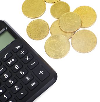 Calculator with gold coins on isolated white background