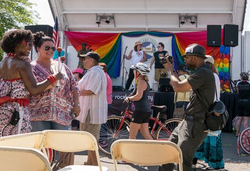 Nyack, NY, USA - June 14, 2015: Photographer takes picture of two smiling drummers from Batalia NYC band during Rockland Pride festival.