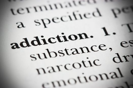 Close up of a dictionary word �addiction�
