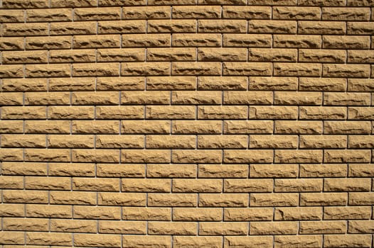 the wall consisting of small light brown bricks