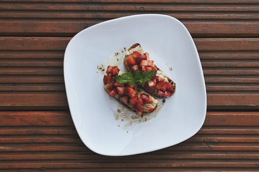 Sandwiches on white plate on old table