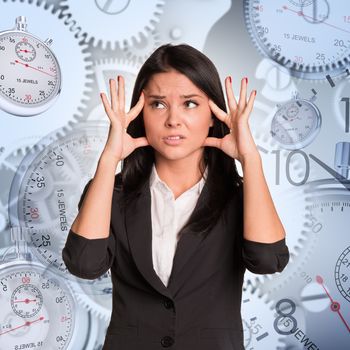 Nervous businesswoman on abstract background with clocks