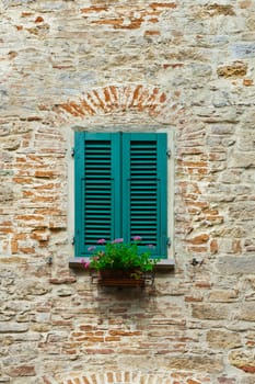 Italian Window with Closed Wooden Shutters, Decorated With Fresh Flowers