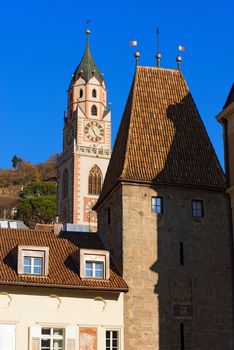 Detail of the bell tower of the Cathedral and Porta Bolzano (XIV century) in Merano, Bolzano, Trentino Alto Adige, Italy