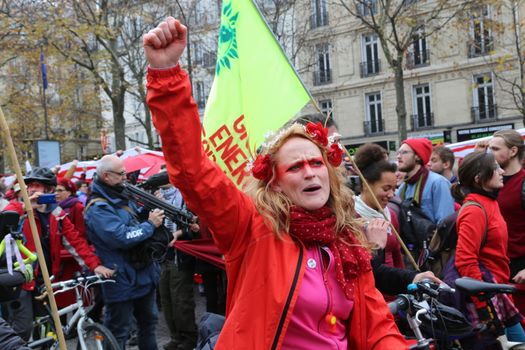 FRANCE, Paris : A demonstrator raises her fist during a climate march organized in Paris on December 12, 2015 as the COP21 negotiations come to an end.
