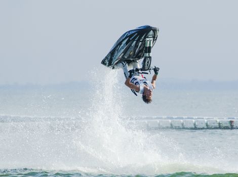 Pattaya, Thailand - December 6, 2015: Taiji Yamamoto from Japan during his performance at the freestyle competition during the International Jet Ski World Cup at Jomtien Beach, Pattaya, Thailand.