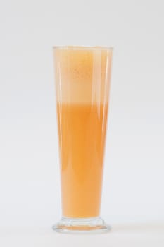 smoothie orange colour in tall glass on white background