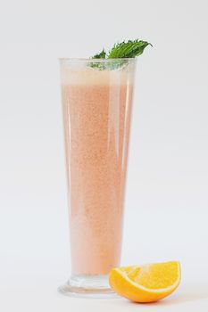 smoothie with orange and mint on white background