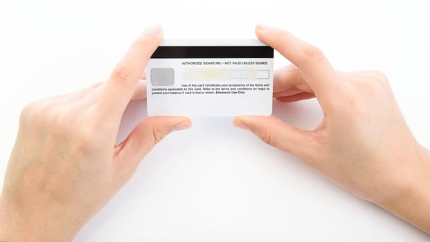 Close up of hand holding credit card on white background