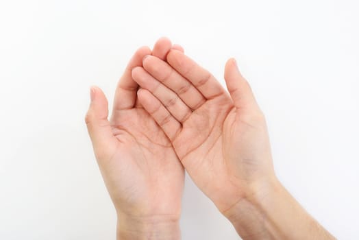 Empty hands resting on top of a  white plain background