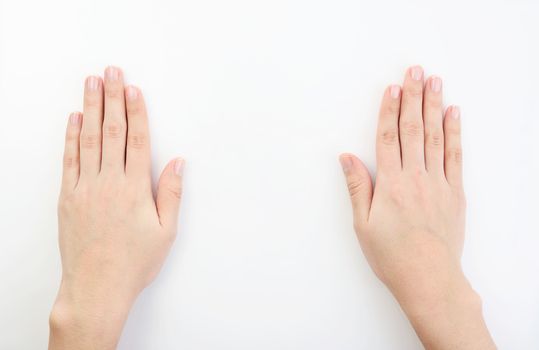 hands resting on top of a  white plain background