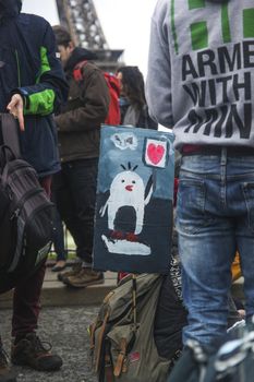 FRANCE, Paris : A sign showing a penguin holding a heart sign is seen on the Champ-de-Mars, near Paris Eiffel tower on December 12, 2015 as thousands of people demonstrate for environment protection. 