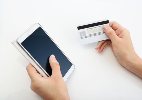 Buying with credit card via smartphone on white background