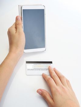 Buying with credit card via smartphone on white background