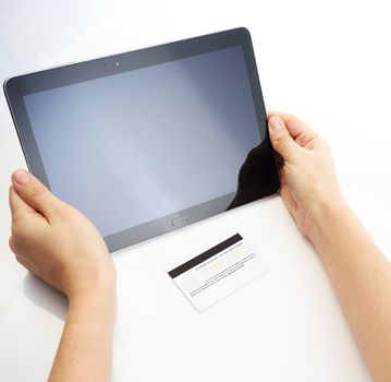Buying with credit card via tablet on white background
