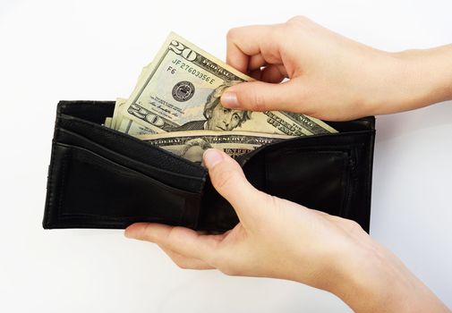 Person taking twenty dollars money from black wallet