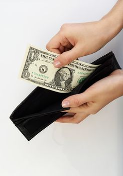 Person taking one dollar bill money from black wallet