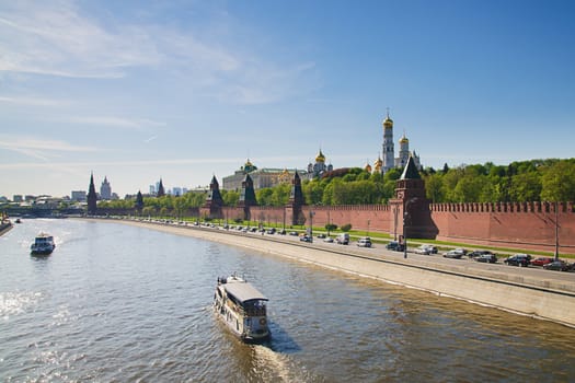Boat moving next to Kremlin wall in Moscow on sunny day