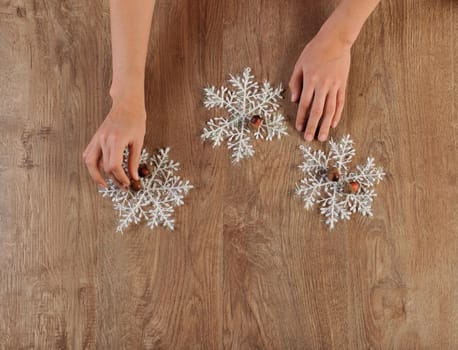 decorater making christmas toys on wood floor