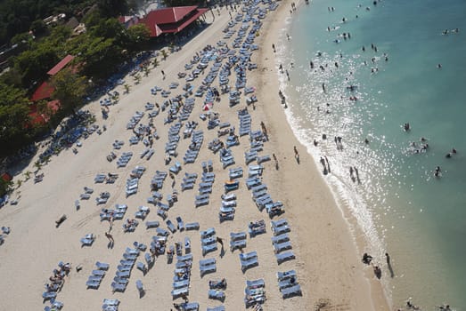 People relaxing on beach chairs in caribbean