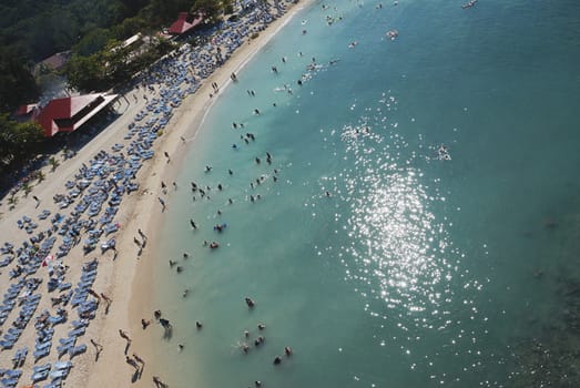 People relaxing on beach chairs in caribbean